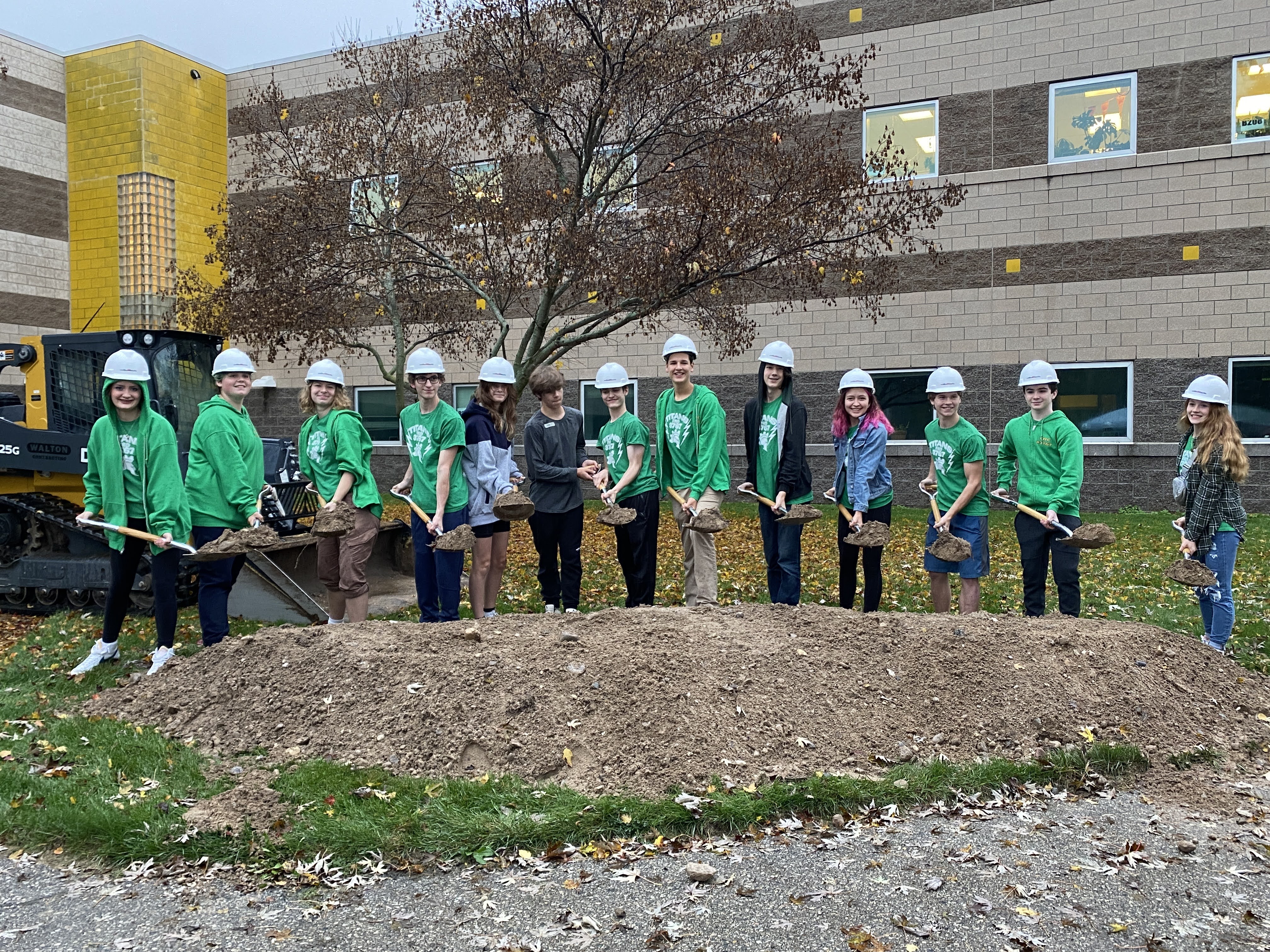 A group of students holding shovels in groundbreaking ceremony.